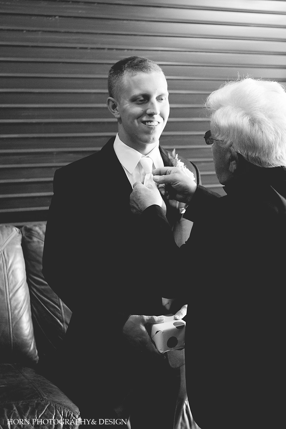 Groom getting ready in black and white photo