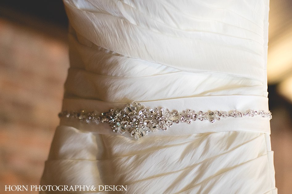 Bejeweled belt on brides dress