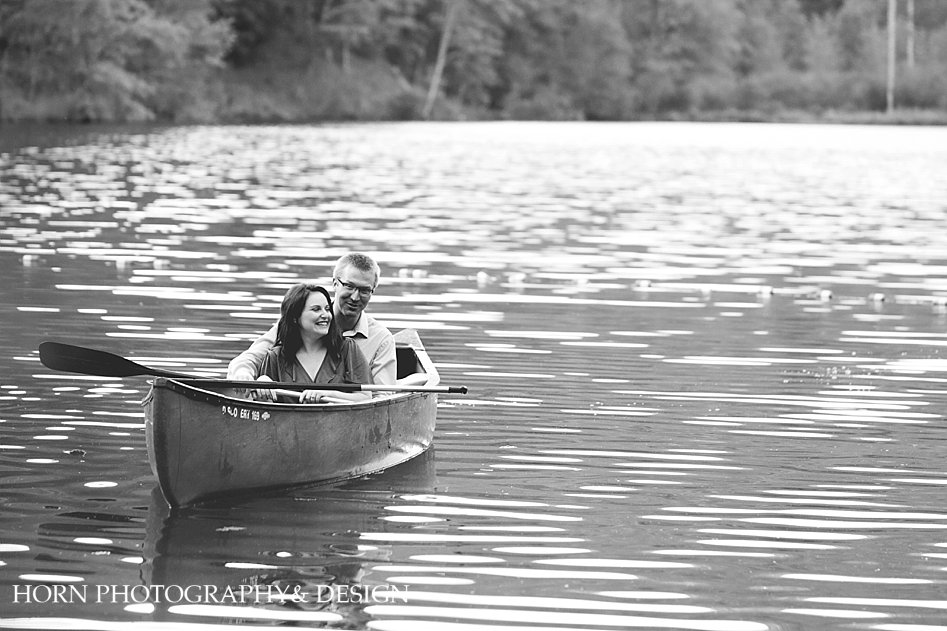 black and white couple in canoe on lake in north georgia mountains horn photography and design atlanta wedding photographers husband and wife team