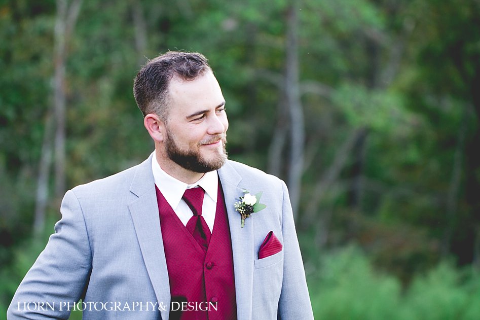 classy groom in grey suit with wine colored vest