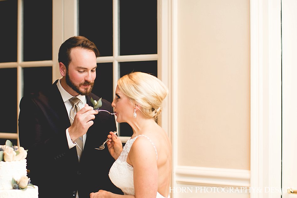Chattahoochee Country Club Wedding Horn Photography and Design bride and groom eat cake