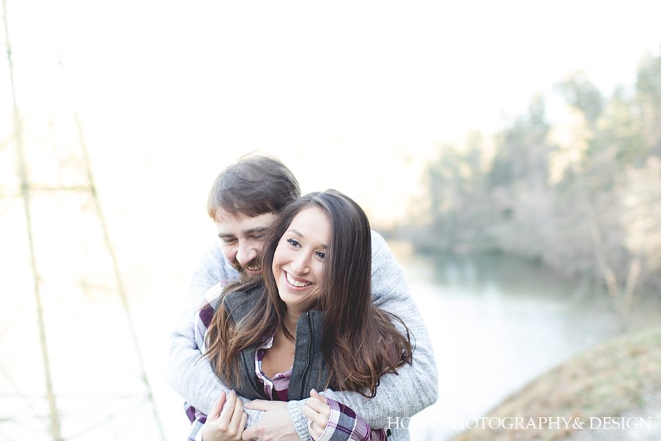couple embraces for an Adventurous Engagement Horn photography and design Dahlonega GA husband and wife photographers