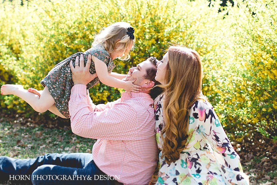 father holds daughter in air family portraits Dahlonega ga lifestyle photographer 