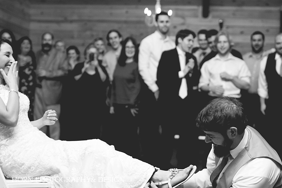black and white removal of garter Willow Creek Farm Wedding Horn Photography and Design Dahlonega Photographer