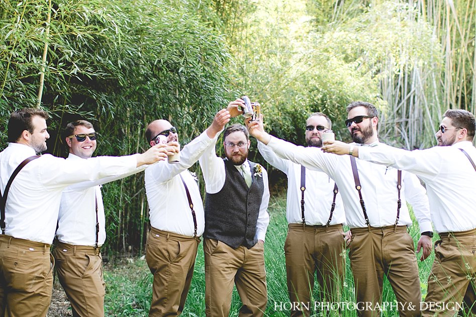 bright wedding photography groomsmen with drinks groomsmen suspenders