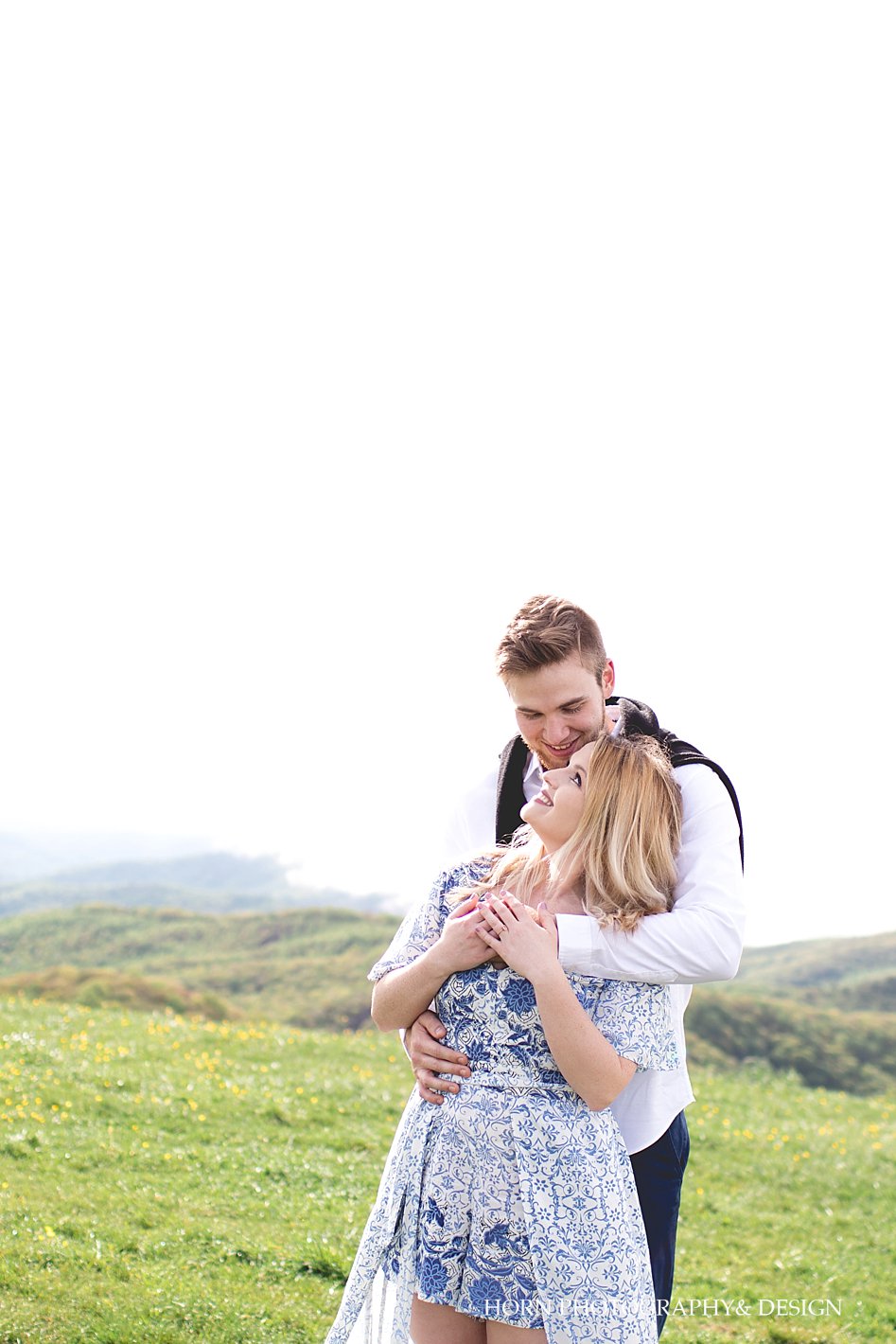 guy holds girl on top of mountain Max Patch Engagement Shoot