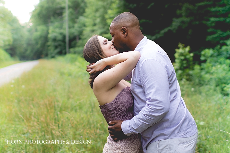 interracial couple engaged pose roadside kiss kissing horn photography and design Dahlonega ga