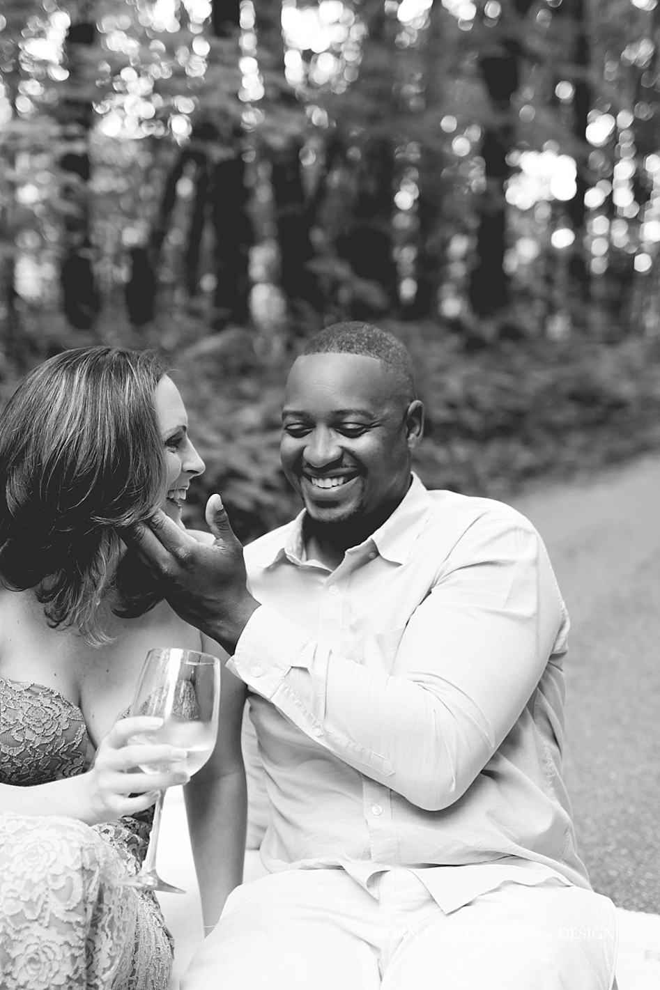 groom laughs with bride drinking wine Dahlonega Engagement