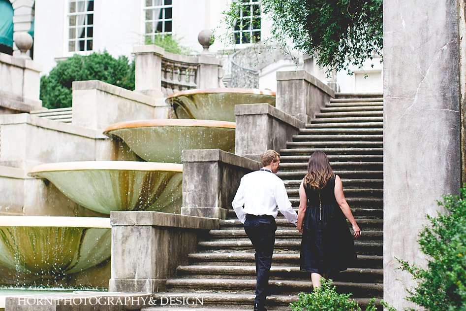 couple walks holding hands up stairs swan house horn photography and design