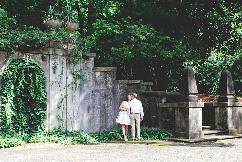 girl and guy kiss outside Swan House Engagement Shoot Horn photography and design 
