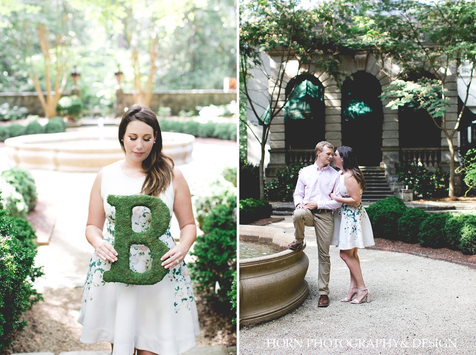 couple poses by fountain girl poses with sign Swan House Engagement Shoot Horn photography and design