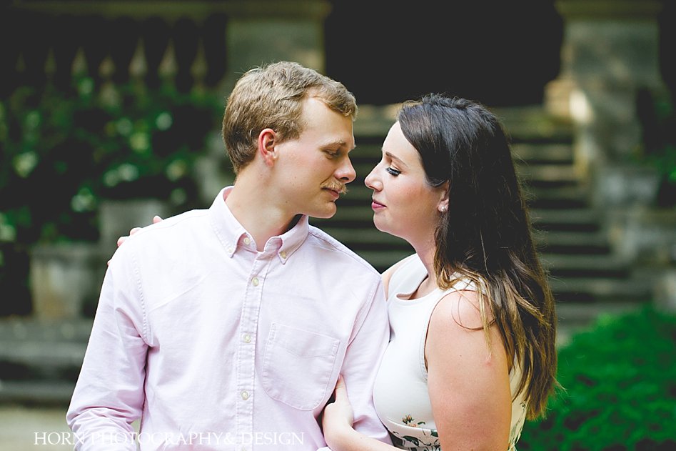 man with mustache looks into woman's eyes Swan House Engagement Shoot Horn photography and design