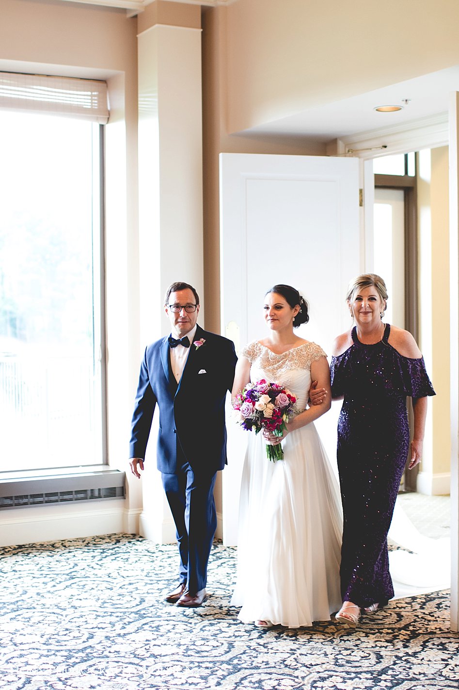 bride enters room with parents