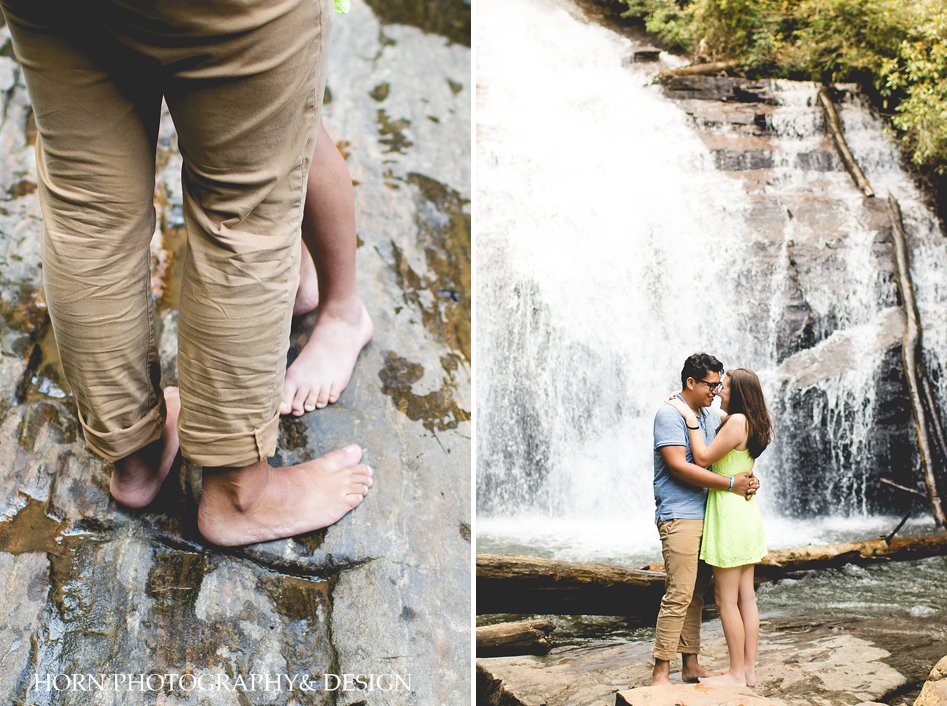 feet on a rock fiancé hugs in front of waterfall