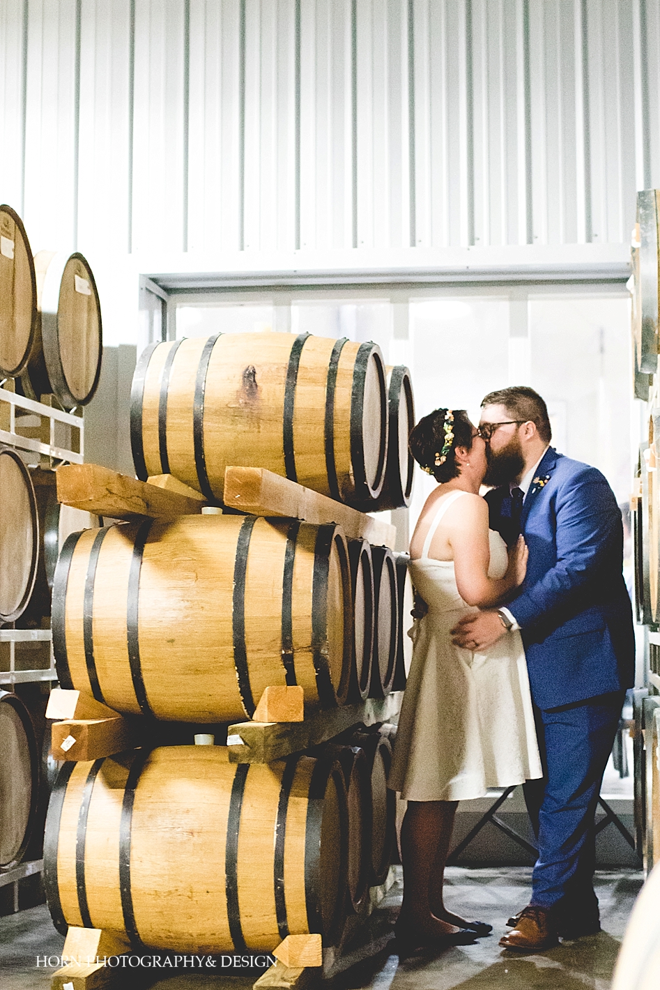 whiskey distillery barrel room couple kisses St. Petersburg Florida Wedding