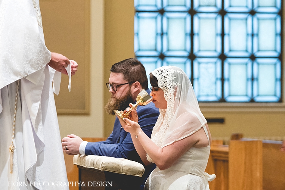bride receives communion at catholic wedding