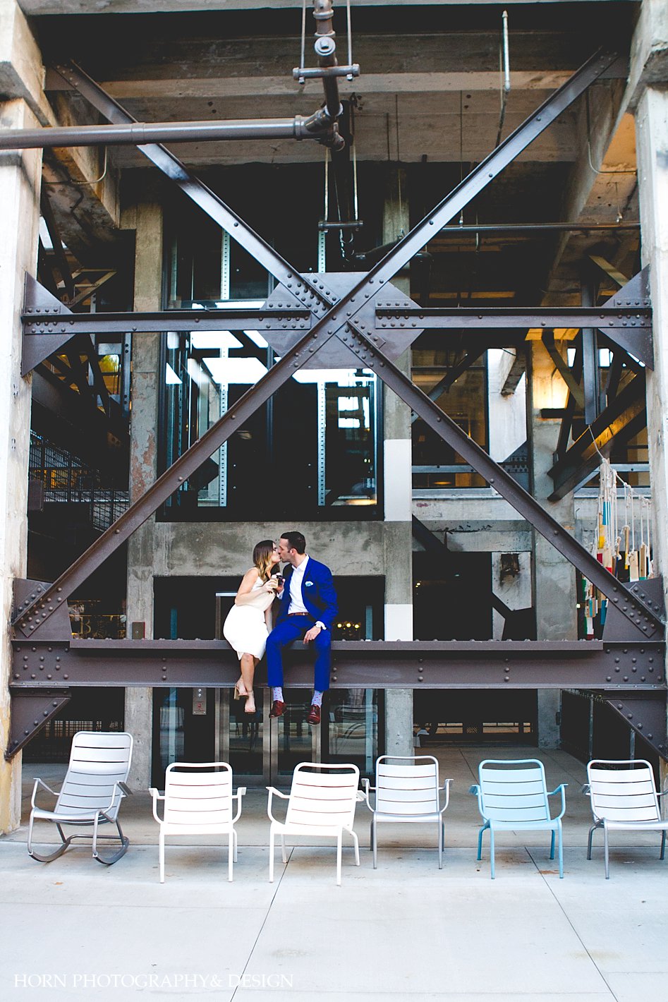 Engagement Session Tip Ponce City market engagement couple sits on beam guy in royal blue suit
