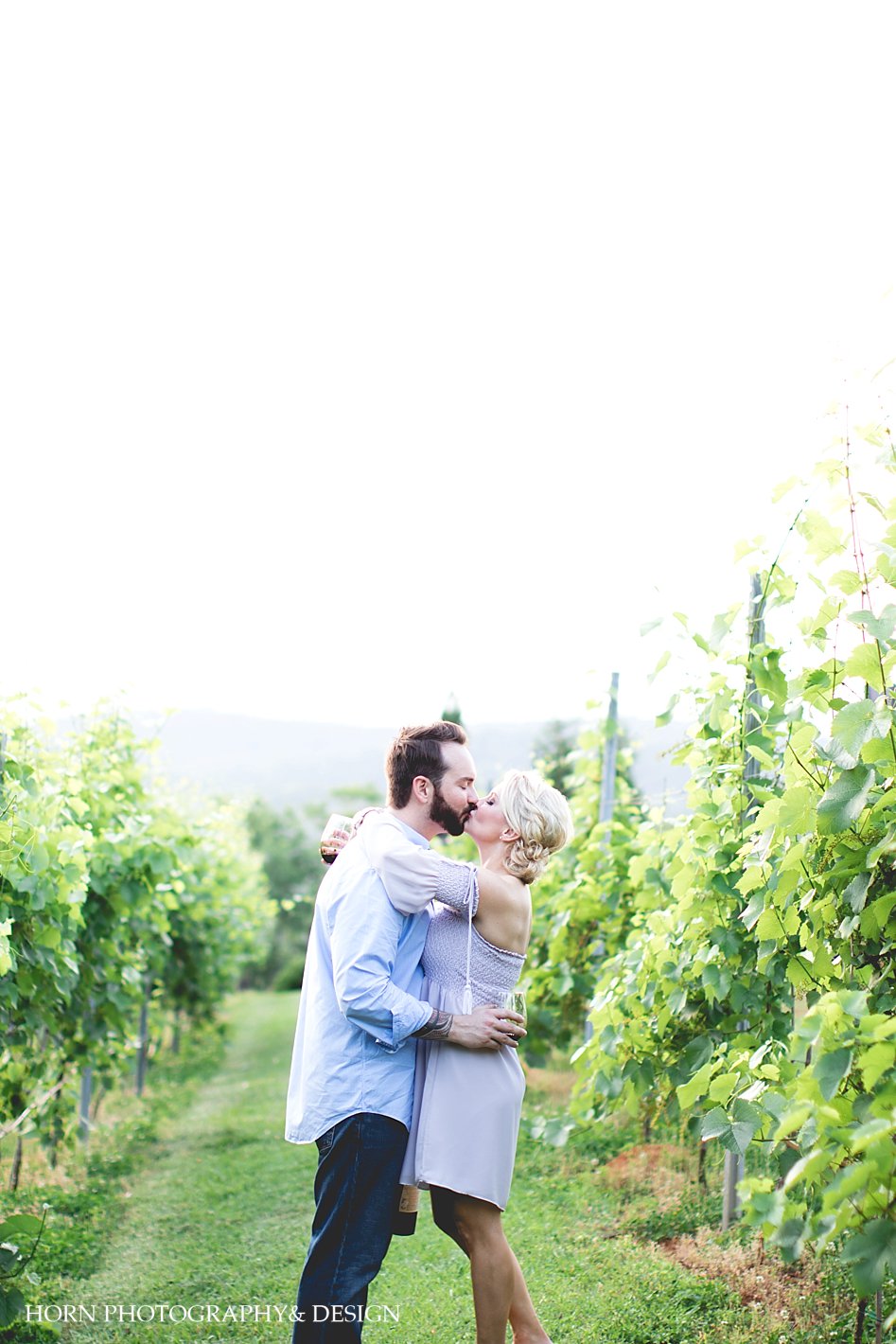 couple kissing in vineyard Dahlonega Georgia north Georgia wine country blue mountain vineyards