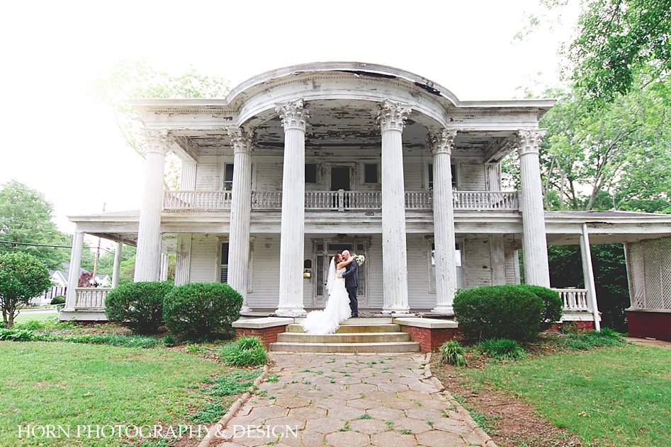 Bride Groom pose infront of historic mansion