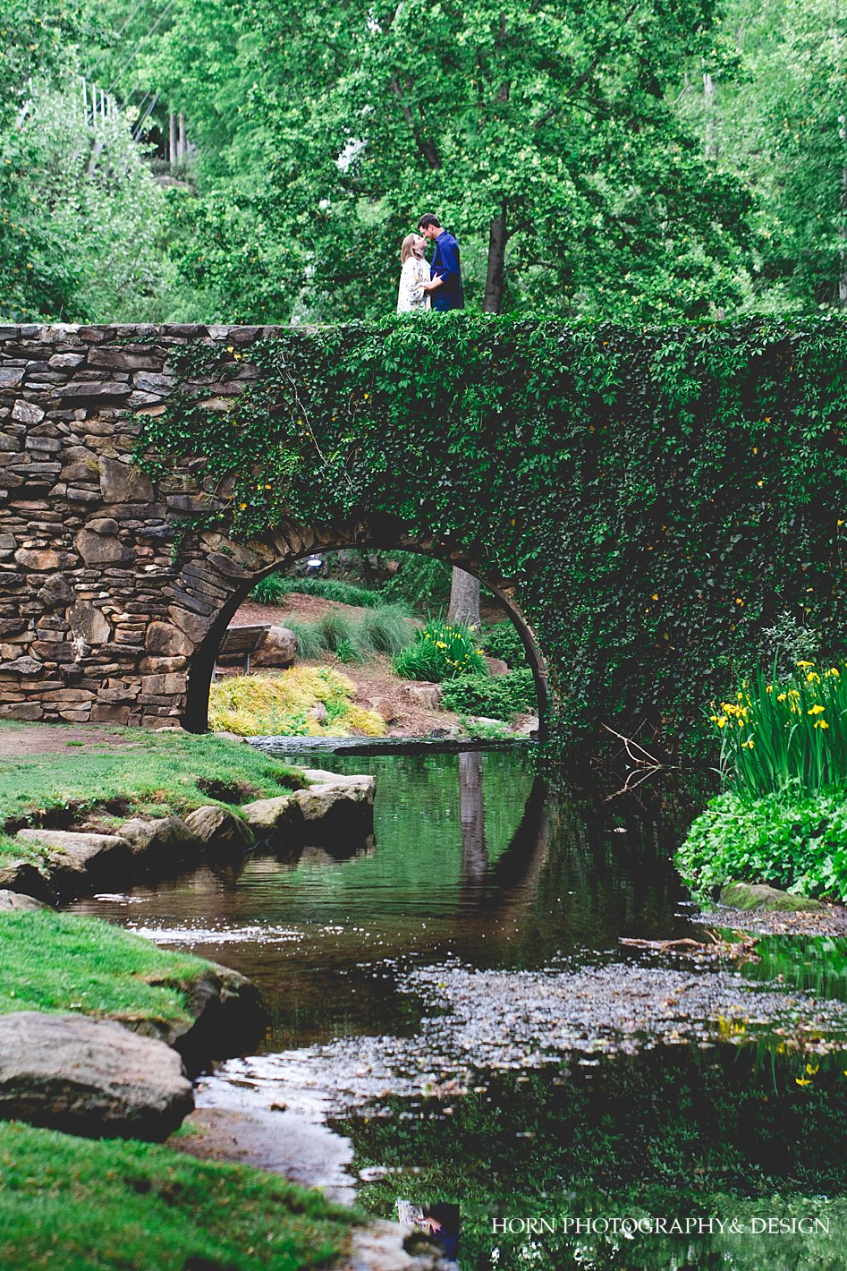 couple stands on beautiful bridge