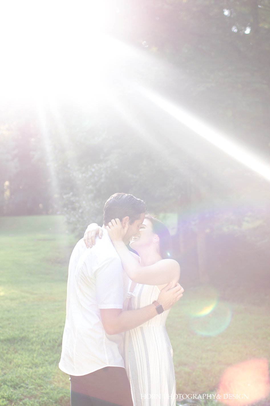 Light Dahlonega Engagement Shoot sun burst couple embraces