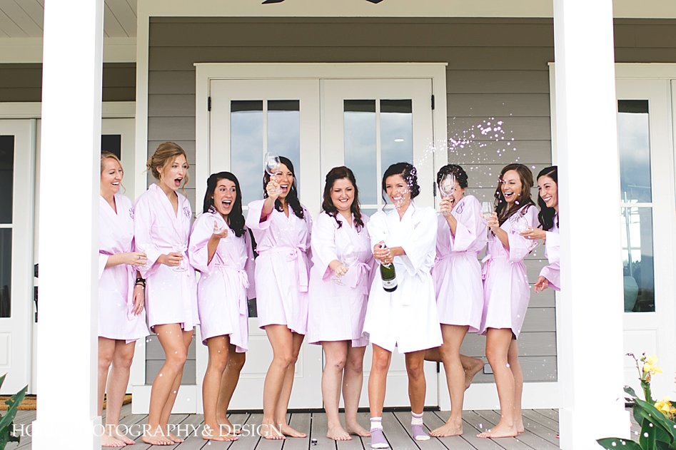 bridesmaids with champagne toast kaya vineyard cottages
