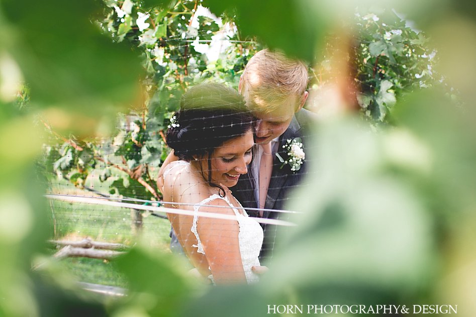 bride and groom in the vines at Kaya Vineyard & Winery Wedding