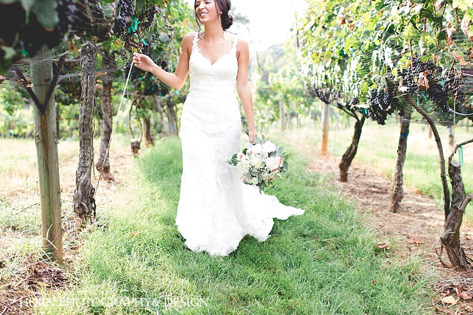 Kaya Vineyard & Winery Wedding bride walking with vines