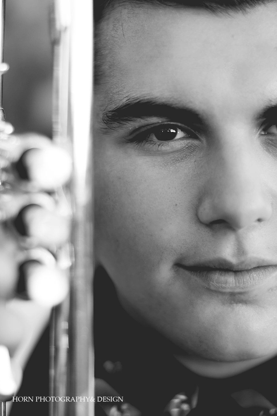 boy senior session black and white face with trumpet