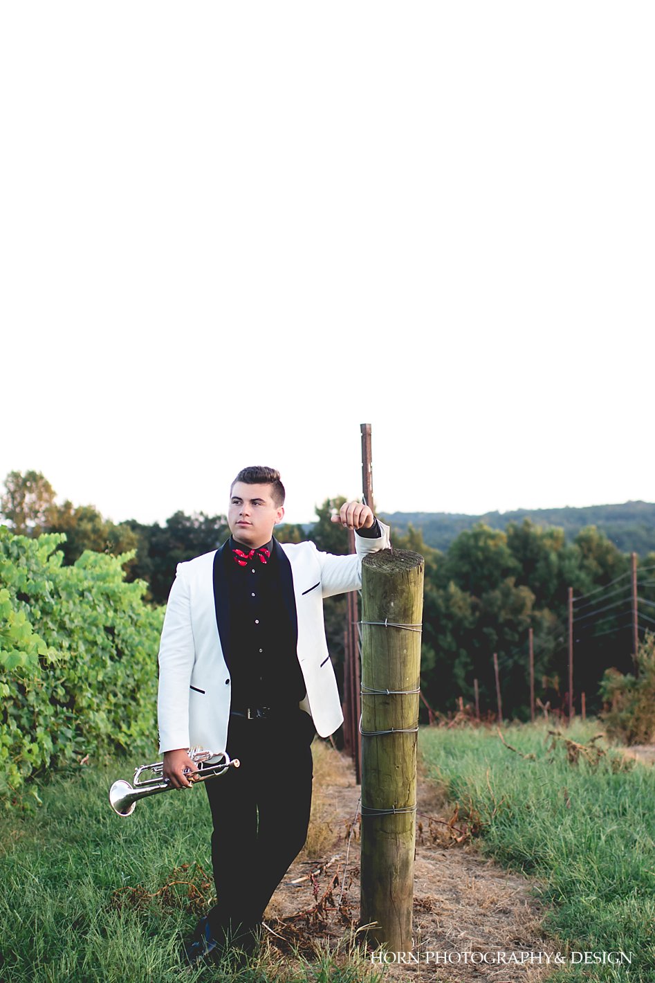 male senior session with trumpet prop