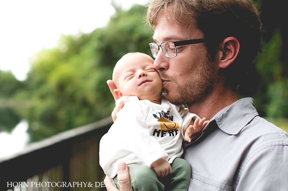 dad on family shoot holding baby
