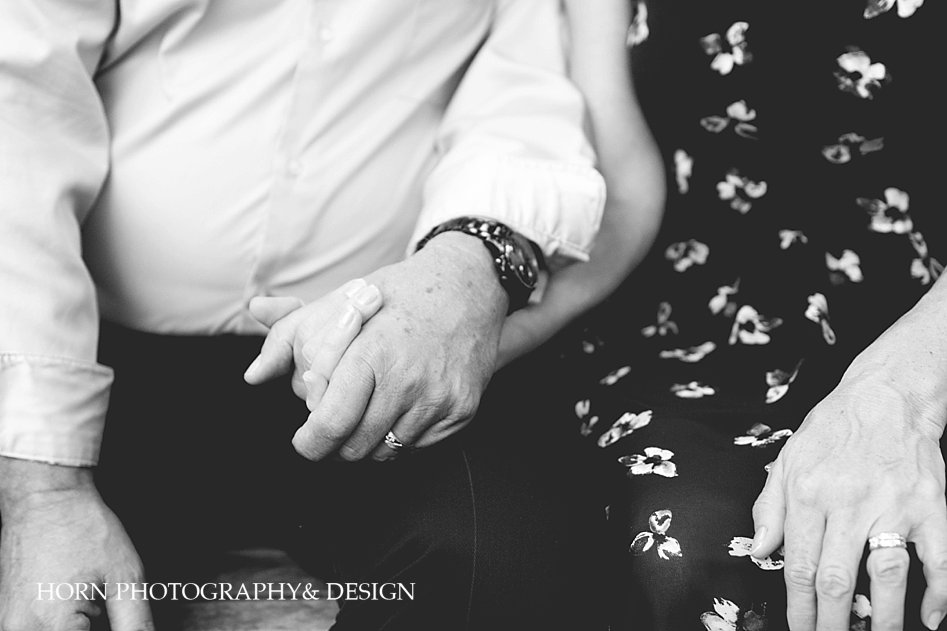 husband and wife hold hands black and white photo