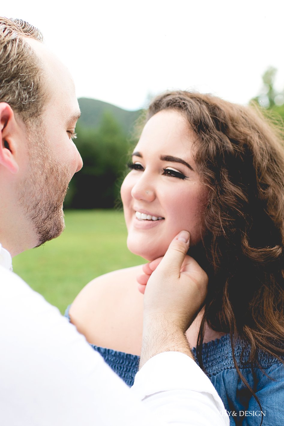 guy places hand on fiancé's chin for Dahlonega Engagement Session