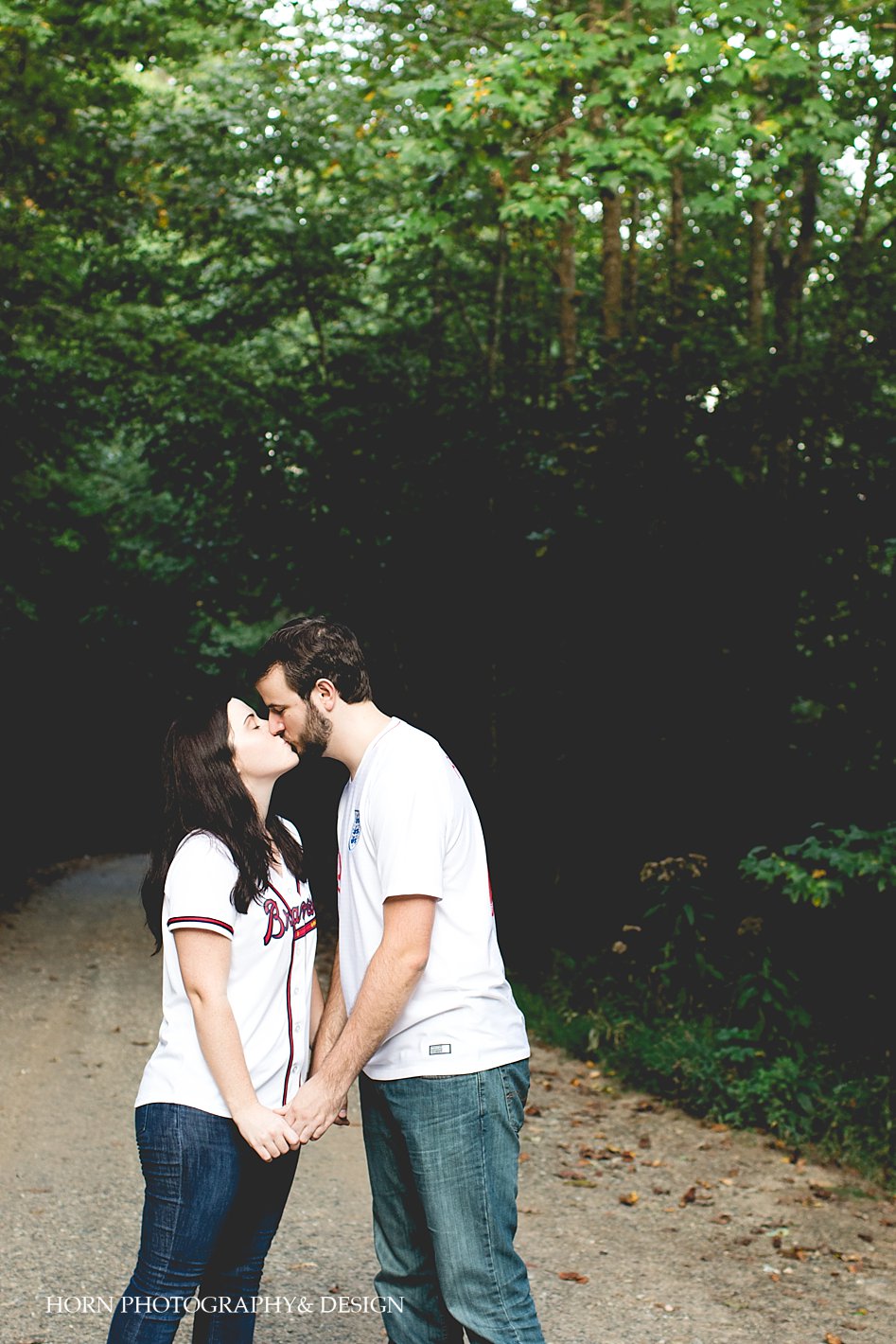 waterfall engagement session couple with jerseys on