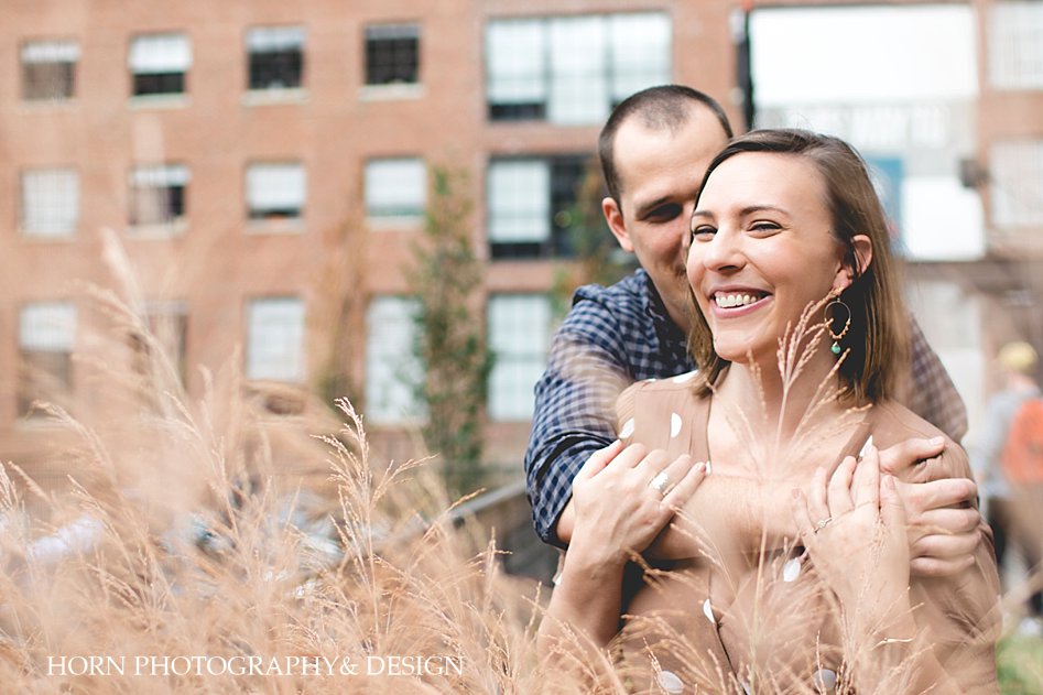 guy embraces girl from behind ponce city market