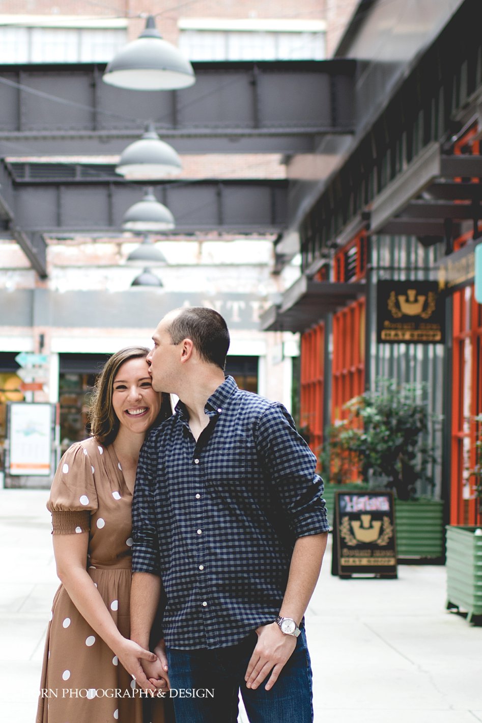 he kisses her forehead during Ponce City Market Engagement Session by Horn Photography and Design