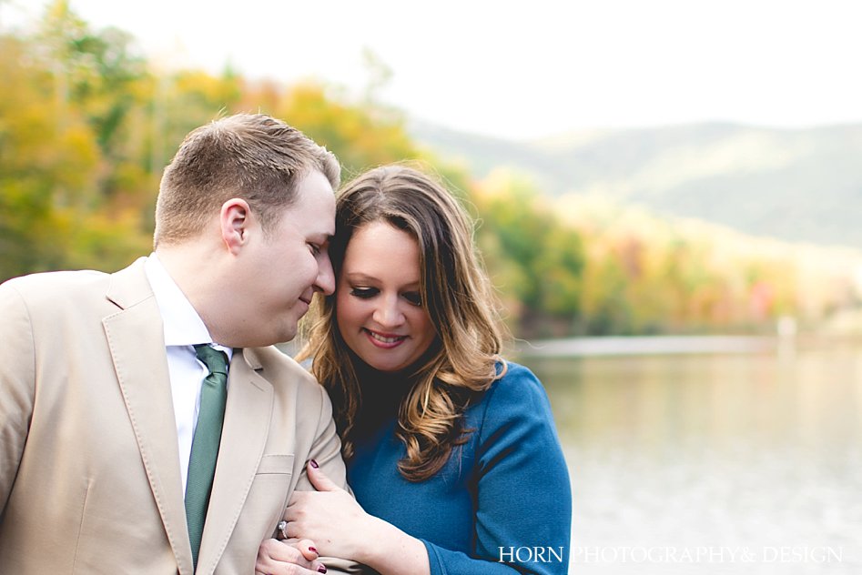 couple snuggles by lake North Georgia Fall Engagement What to wear Horn photography and design Dahlonega photographer