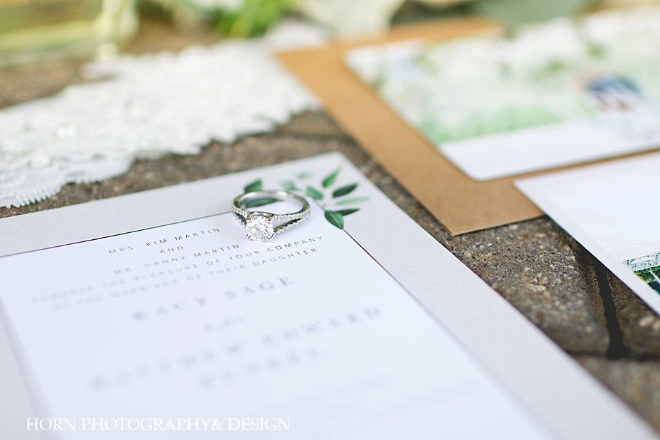 engagement ring with wedding invitations