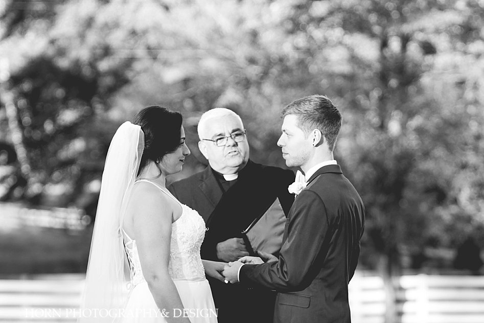 bride and groom exchange rings Ruins at Kellum Valley Farm Wedding Horn Photography and Design