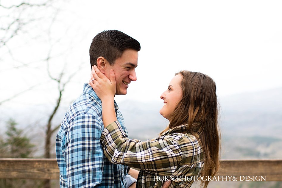 Girl holds guys face Surprise Proposal at Amicalola Falls 