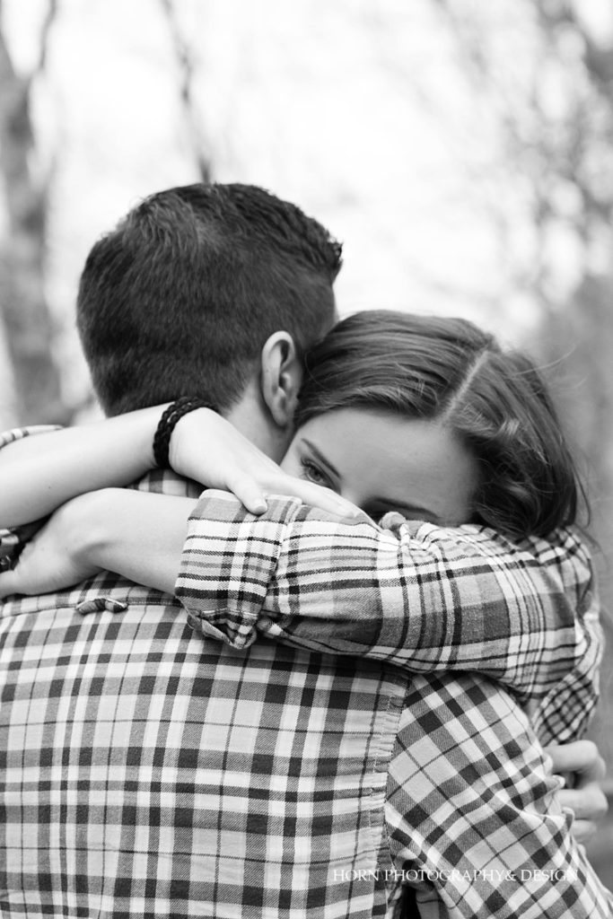 couple embraces hugs Surprise Proposal at Amicalola Falls horn photography and design Dahlonega Georgia photographers 