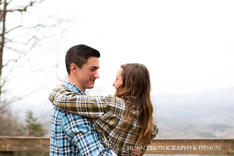 Couple hugs Surprise Proposal at Amicalola Falls horn photography and design Dahlonega Georgia photographers 