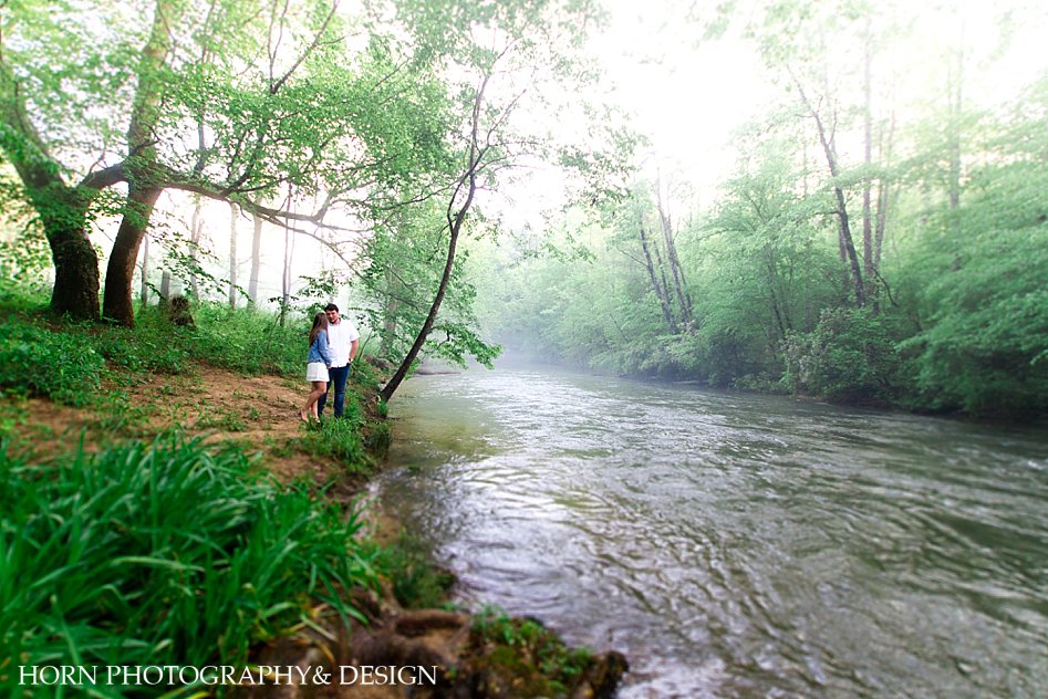 couple by river side Misty Mountain Engagement Session Dahlonega Ga engaged photographer husband wife team