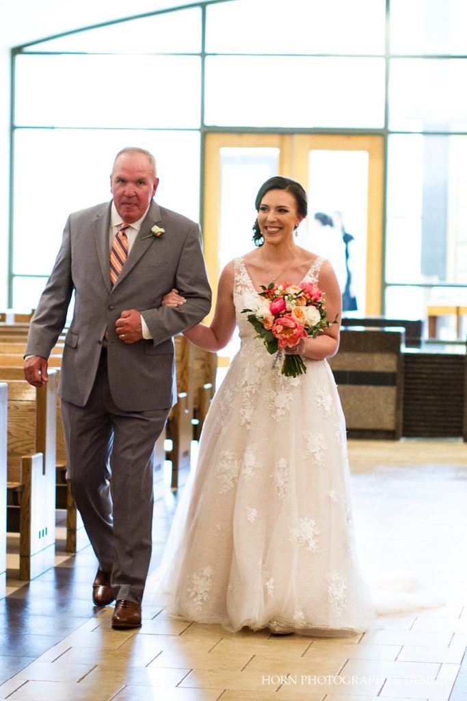 father and daughter walk down the aisle 