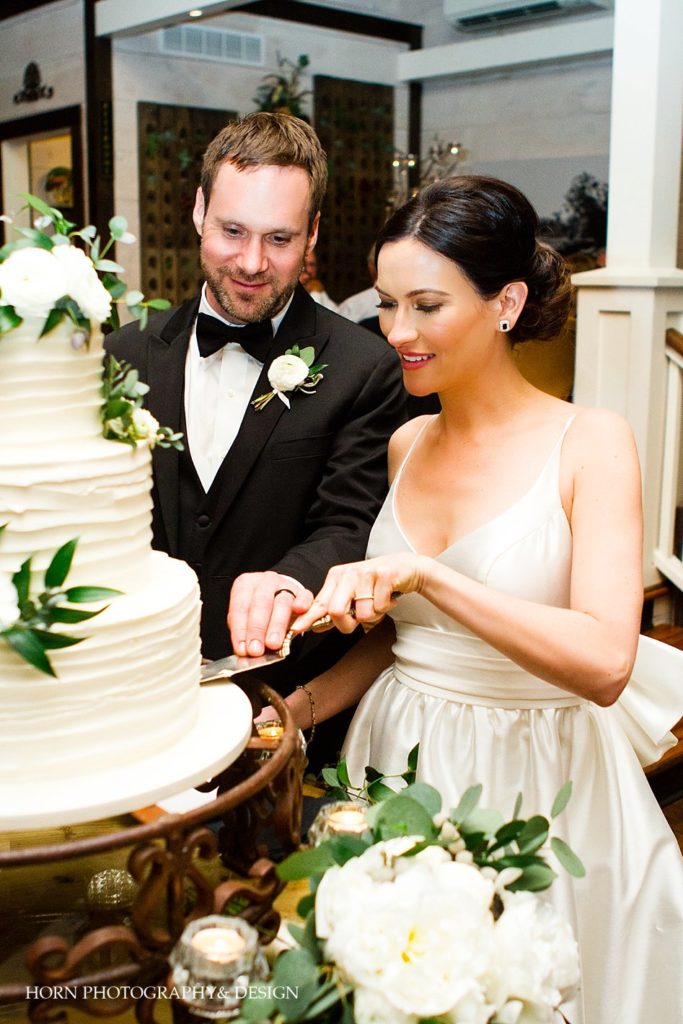 bride and groom cut elegant cake