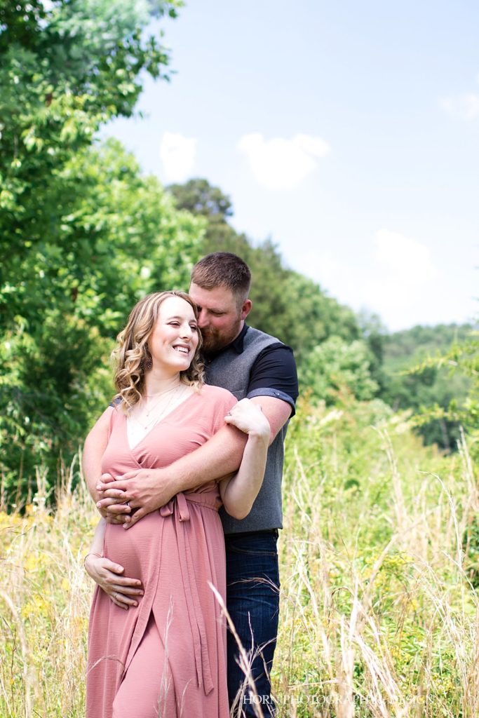husband embraces pregnant wife maternity session