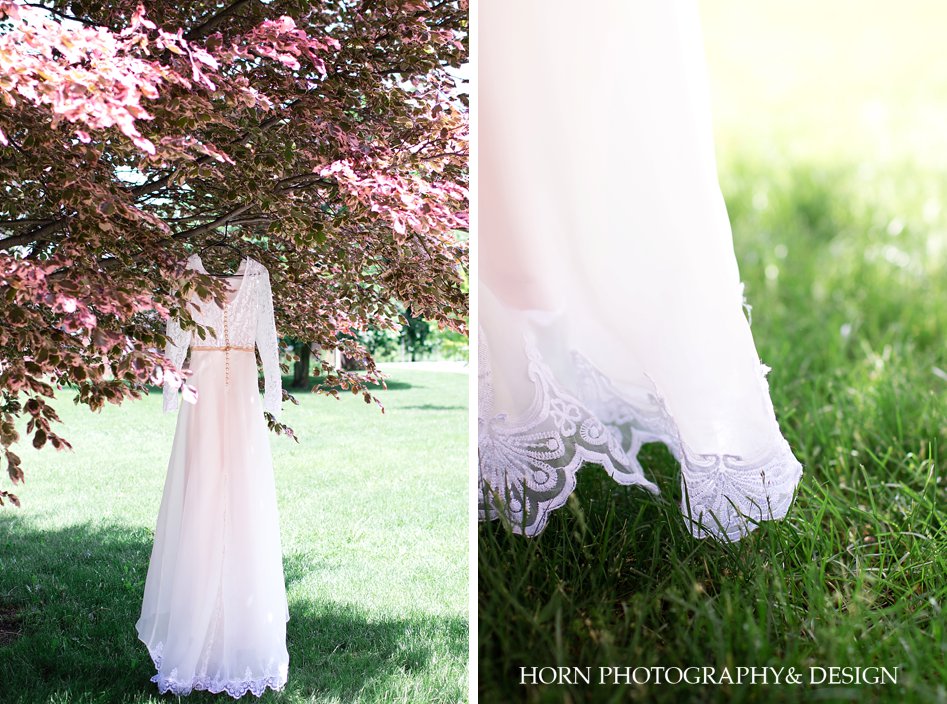 wedding dress hanging from beautiful pink floral tree horn photography and design atlanta wedding photographers