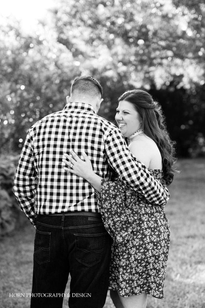 black and white outdoor engagement session candid pose with engagement ring on back Atlanta horn photography and design