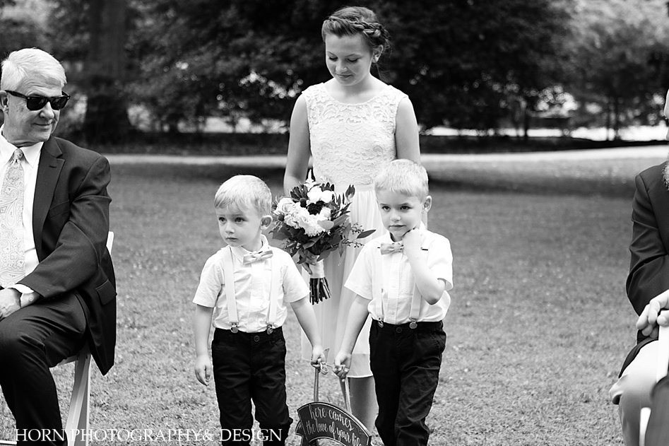 black and white wedding cuties ring bearer in suspenders and bow ties and flower girl in lace dress braided updo horn photography and design