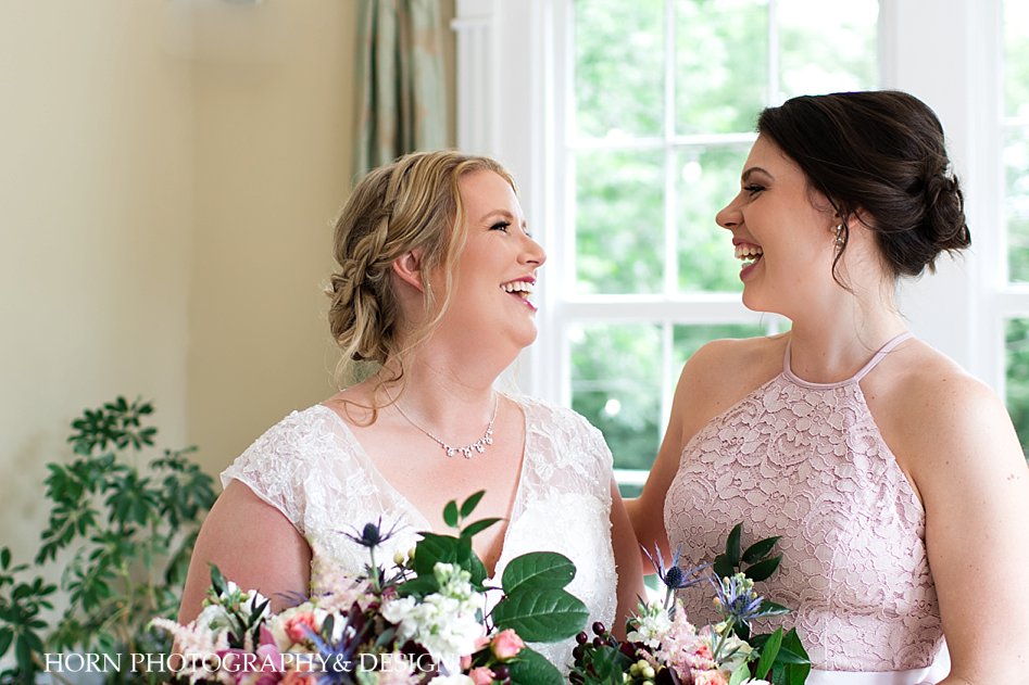 bride and bridesmaid before the ceremony lace blush halter bridesmaid dress Atlanta weddings horn photography and design